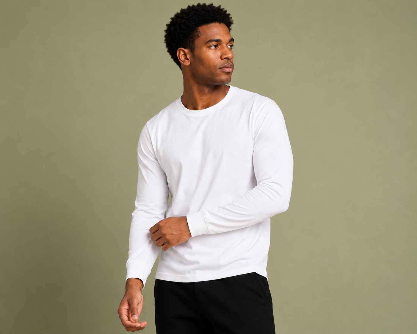 Model wearing a plain white Skyland long-sleeve t-shirt in a studio setting