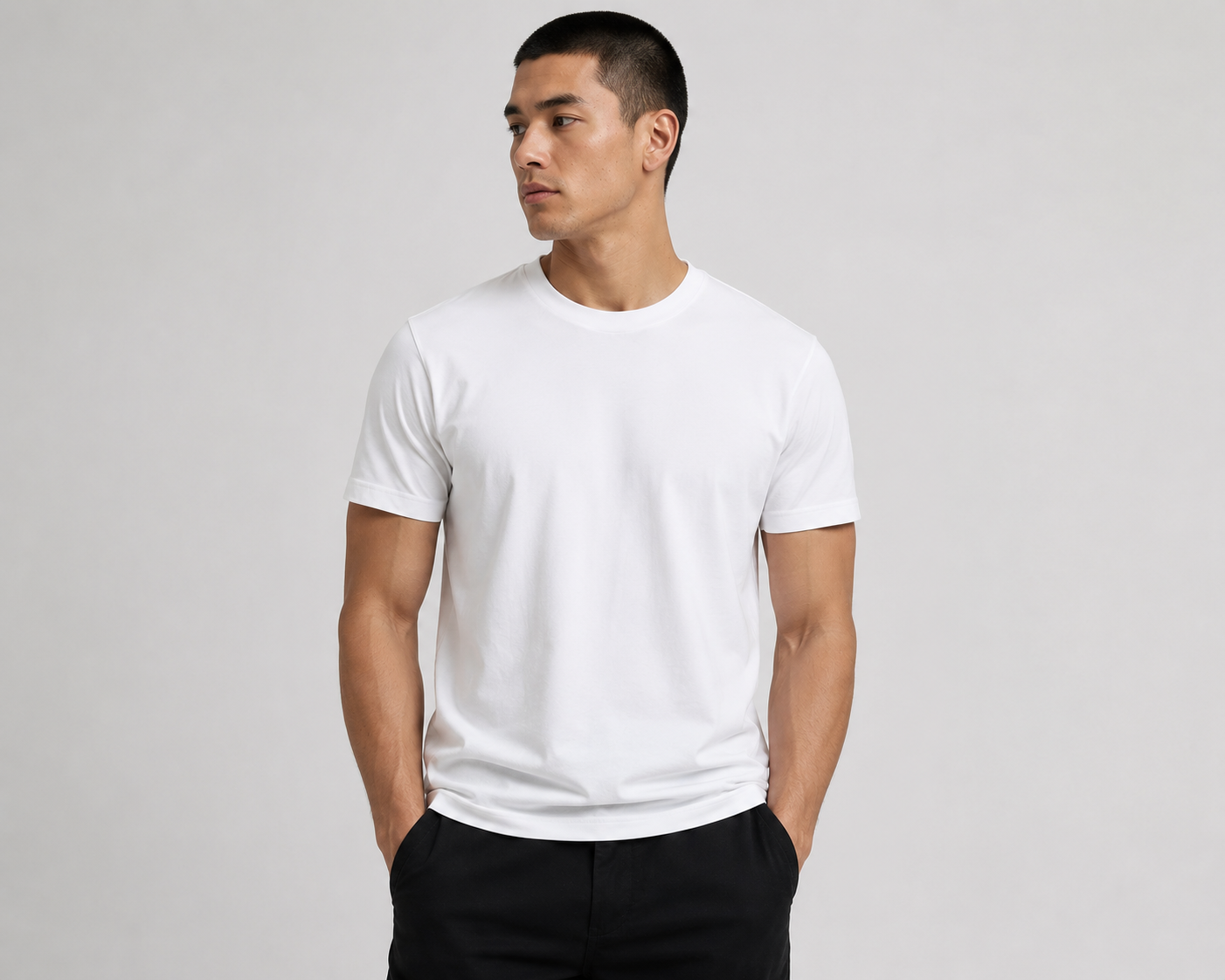 Model wearing a plain white Skyland Tees round neck t-shirt in a studio setting